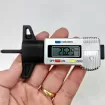 Tire tread depth gauge displays numbers